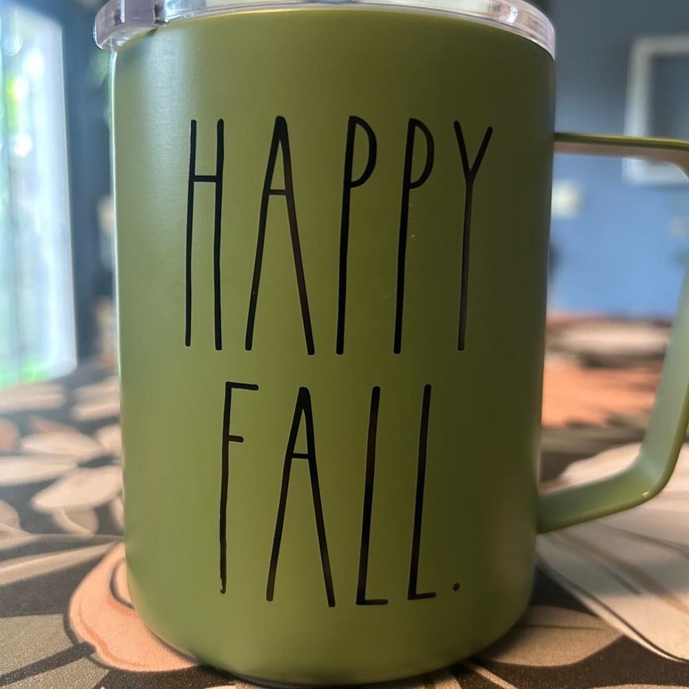 Green Rae Dunn coffee mug with lid.